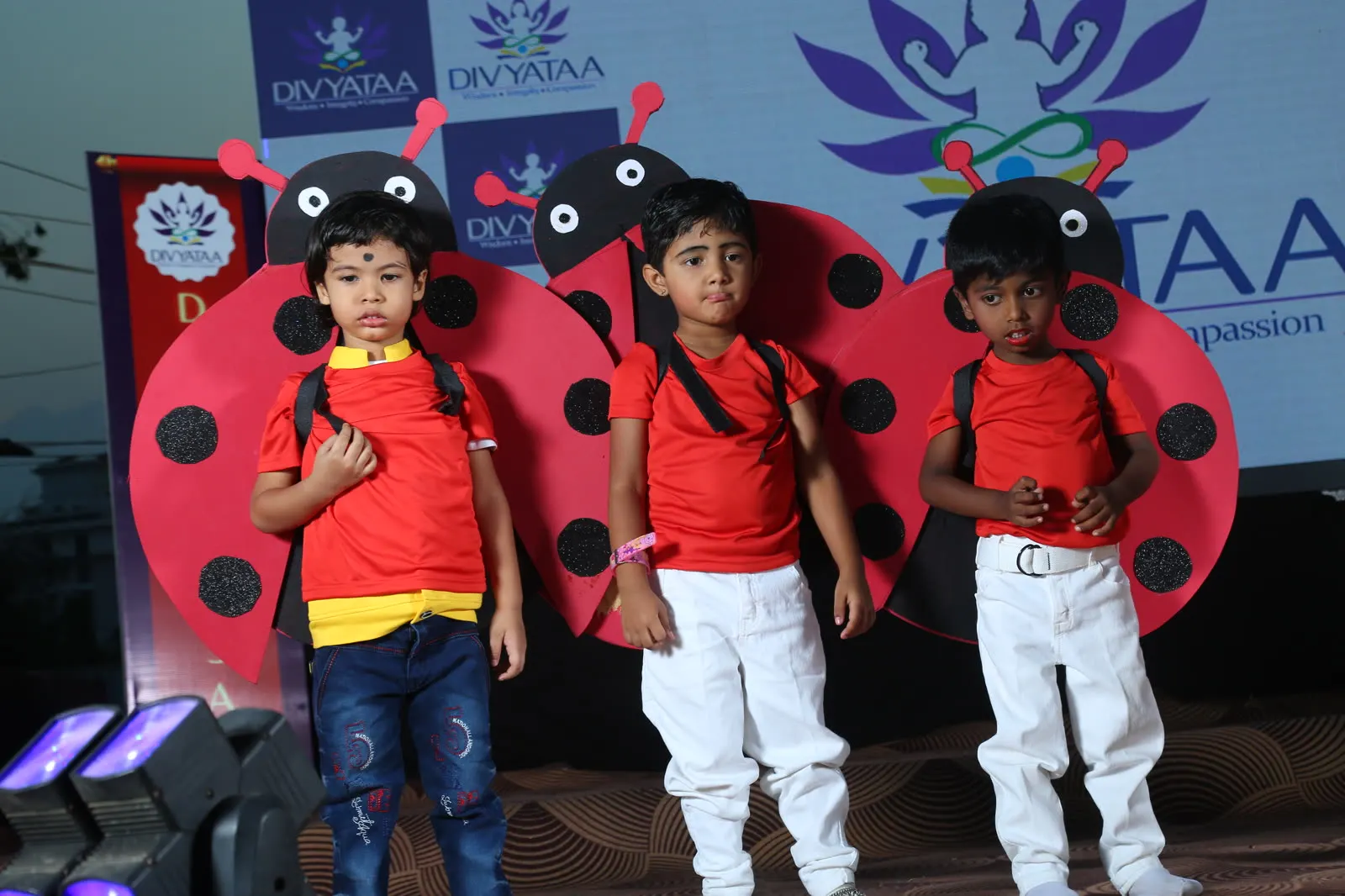 Children dressed as ladybirds performing on stage