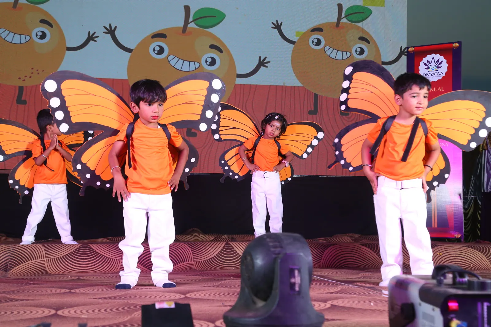 Children in butterfly wings performing a nature dance