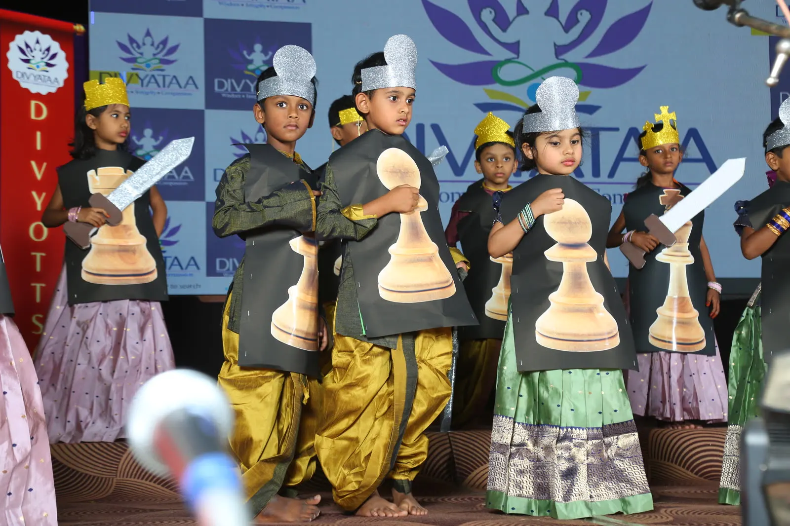 Children dressed as chess pieces performing a skit